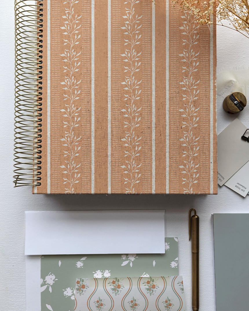 Studio flatlay of art materials and printed patterns